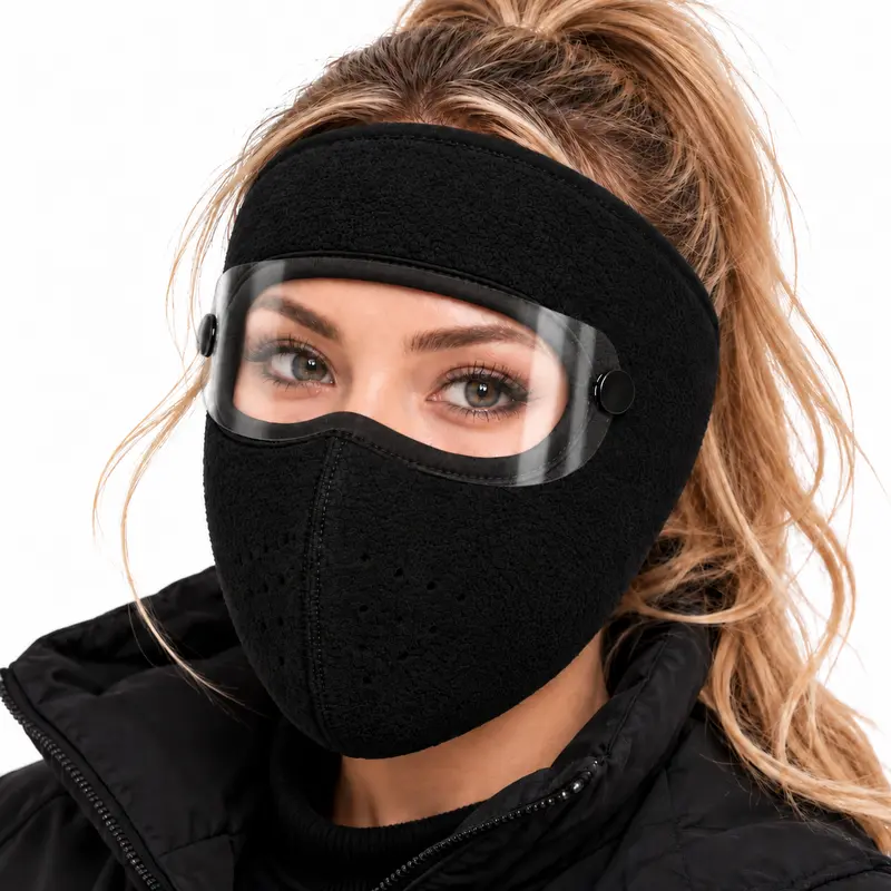 Close-up of the black winter mask with its transparent detachable eye shield and mouth ventilation holes