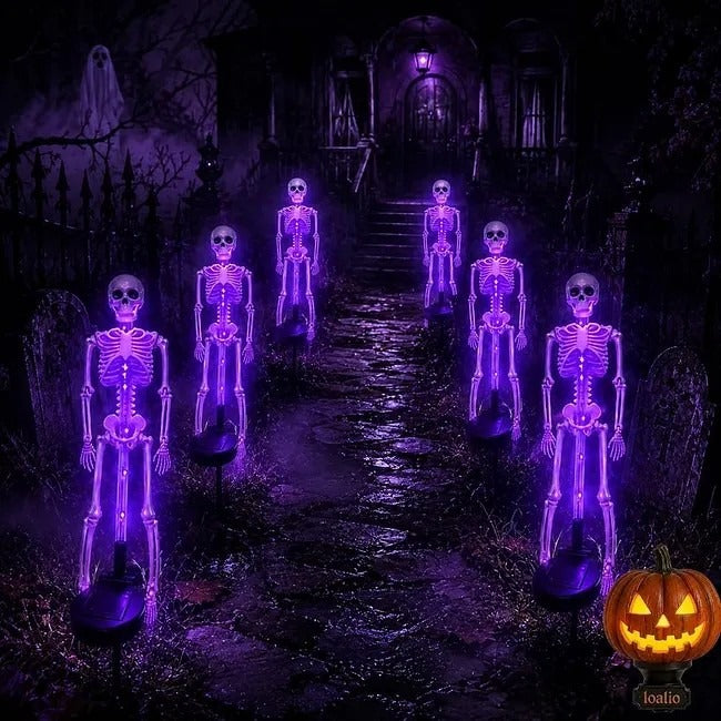Multiple purple skeleton lights lining a dark Halloween pathway